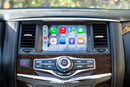 A dashboard of a 2014-2016 Infiniti QX80 with the Hamilton Motor Company Upgrade Kit installed and CarPlay displayed on the screen. 