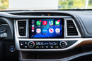 A dashboard of a 2014-2019 Toyota Highlander with the Hamilton Motor Company Conversion Kit installed and CarPlay displayed on the screen. 