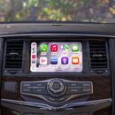 A dashboard of a 2014-2016 Infiniti QX80 with the Hamilton Motor Company Upgrade Kit installed and CarPlay displayed on the screen. 