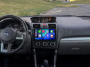 A dashboard of a 2016-2018 Subaru Forester with the Hamilton Motor Company Conversion Kit installed and CarPlay displayed on the screen. 